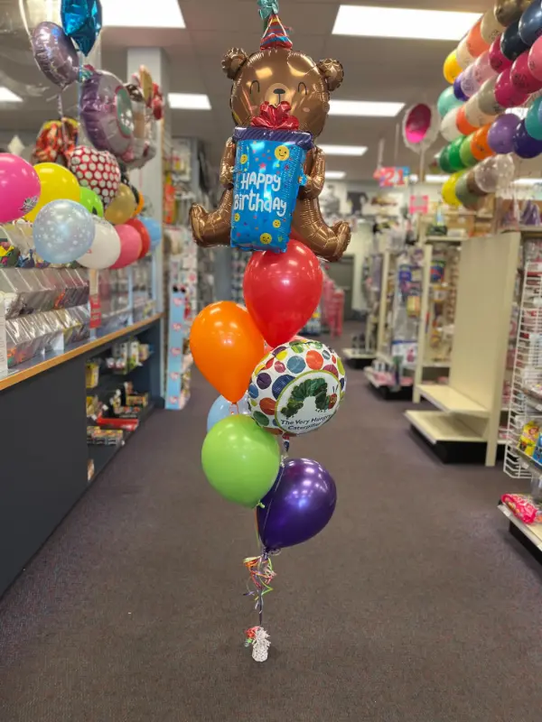 Bear holding gift birthday balloon bouquet